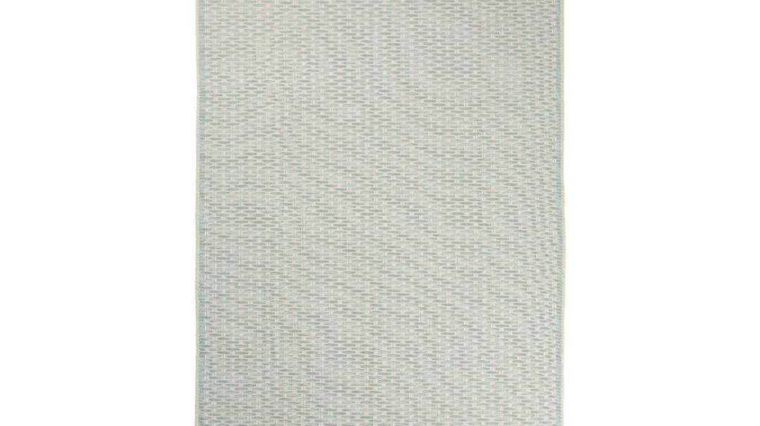 Green geometric check low-pile machine washable area rug in a bright, dust-free living room