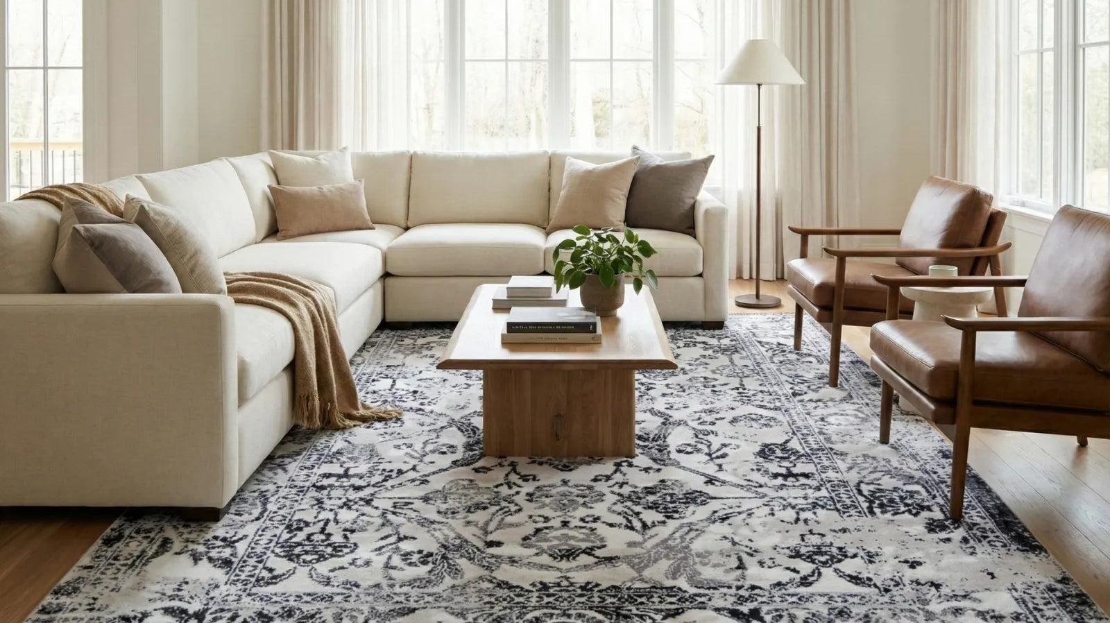 Modern living room with cream sectional sofa, wood coffee table, and Turkish washable area rug