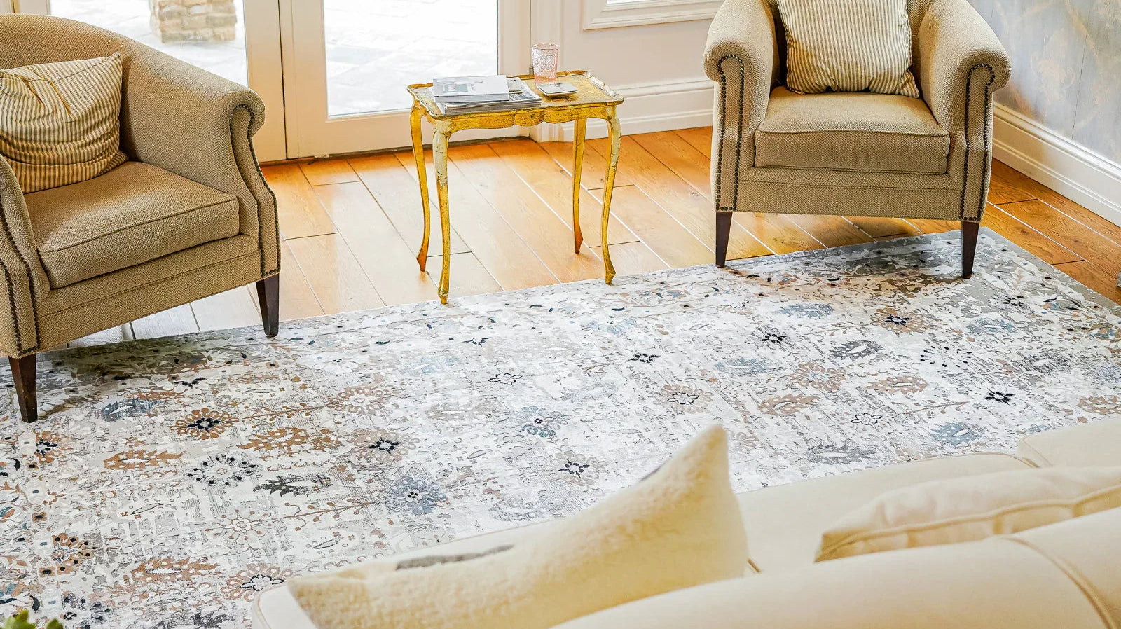 Bohemian style washable area rug in cozy living room with armchairs and wood floor
