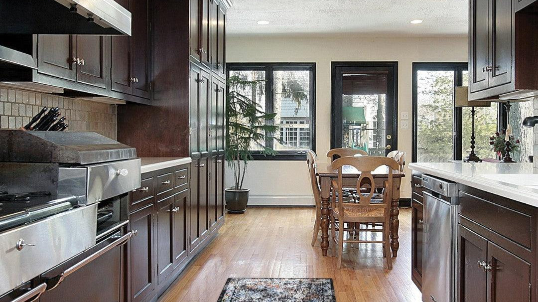 Turkish washable area rug runner in a modern kitchen with wood flooring and dark cabinets