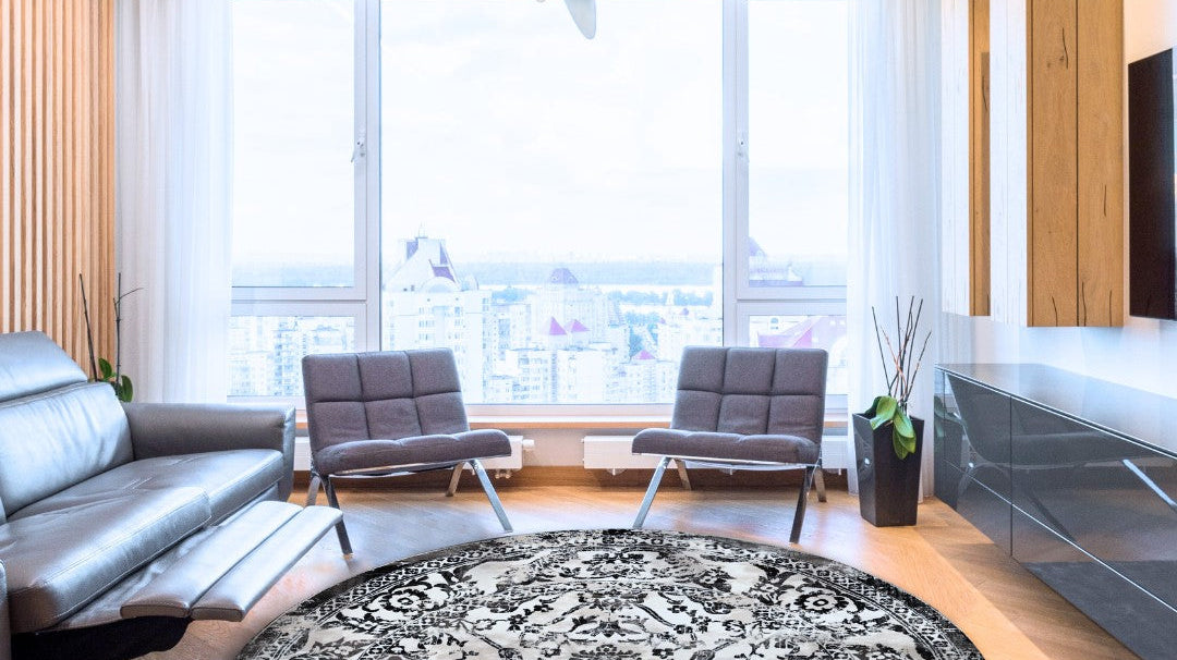 Modern living room with round Turkish washable area rug and large city-view windows