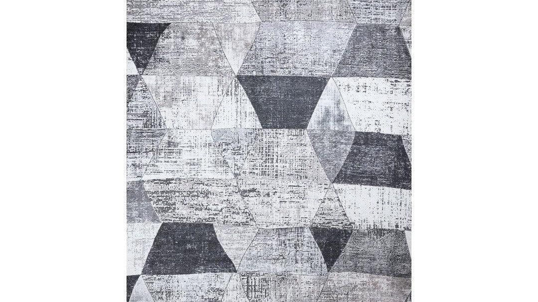 Modern geometric area rug in an 8x10 size anchoring a living room