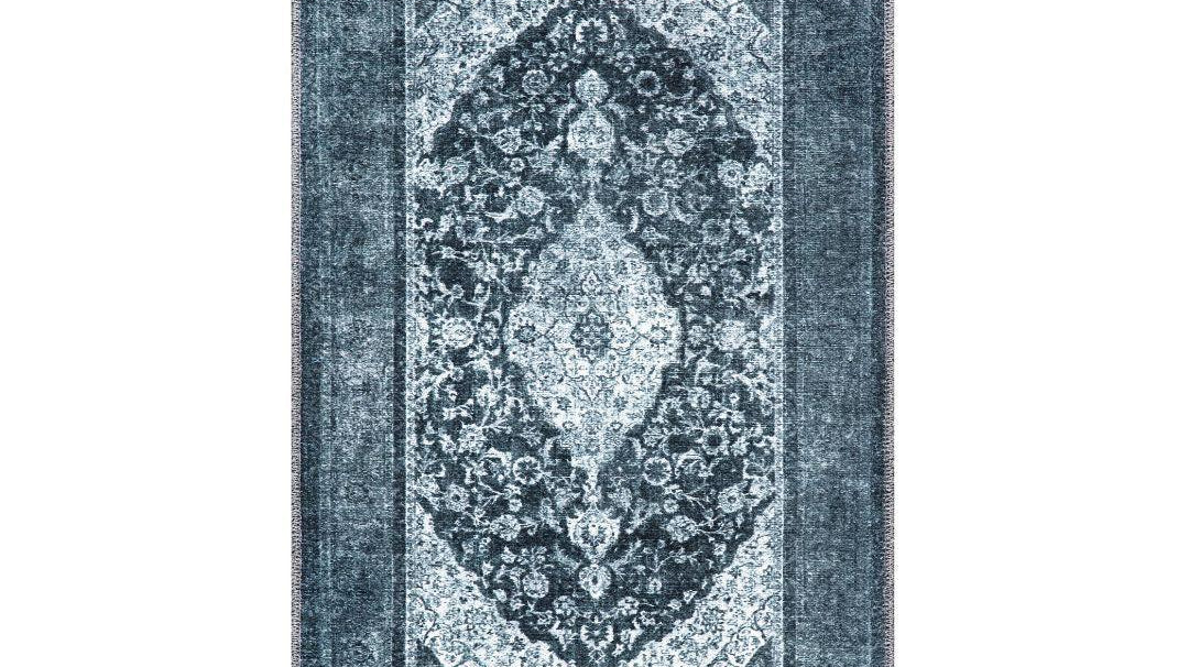 Area rug held flat on carpet with a non-slip rug pad underneath