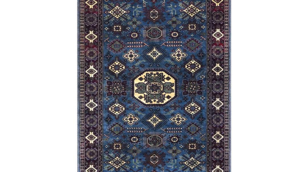 A large navy blue area rug being cleaned at home