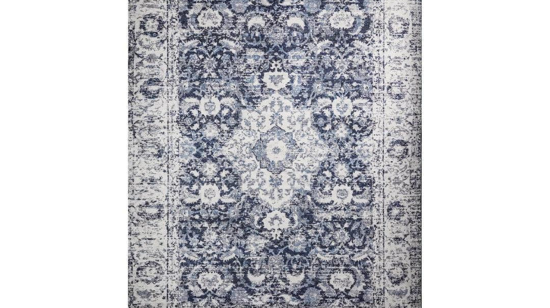 Blue and white floral machine washable area rug compared with a wool rug