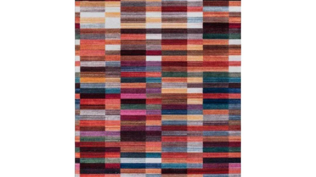 Area rug layered over carpet anchoring a living room seating area