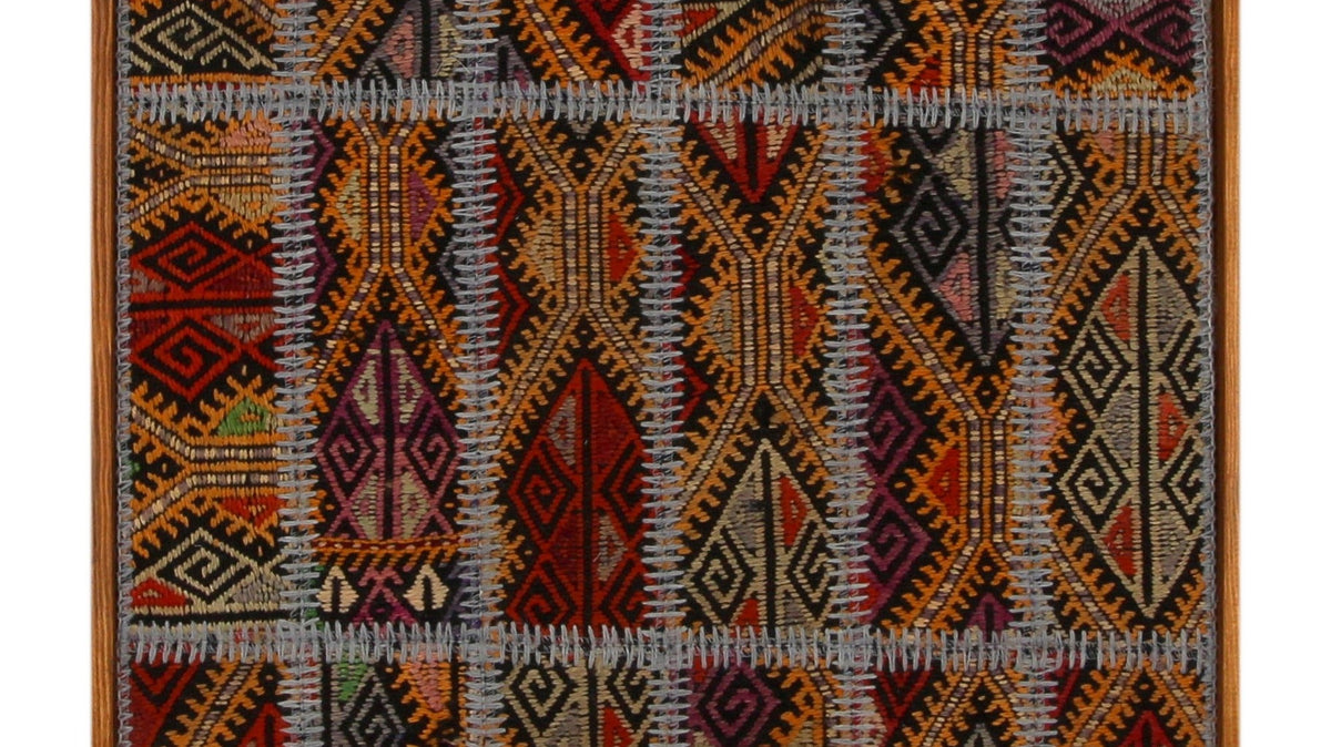 Red and navy Turkish tribal kilim framed as woven wall art