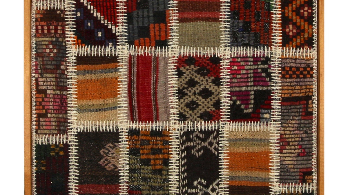 Rust and ivory framed kilim wall art hanging on a wall