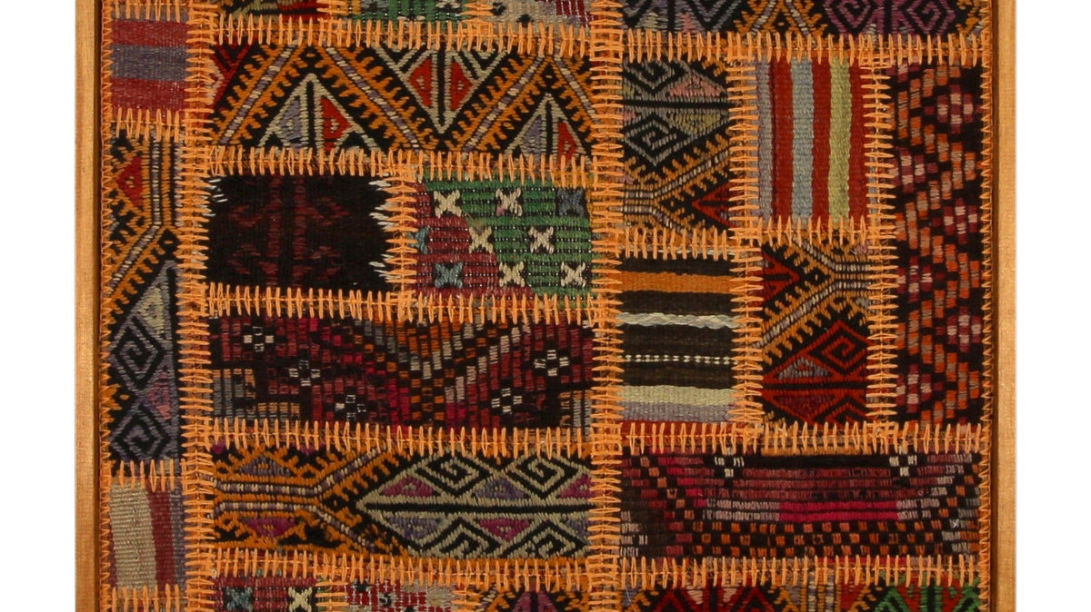 Large orange and emerald kilim wall art above a sofa