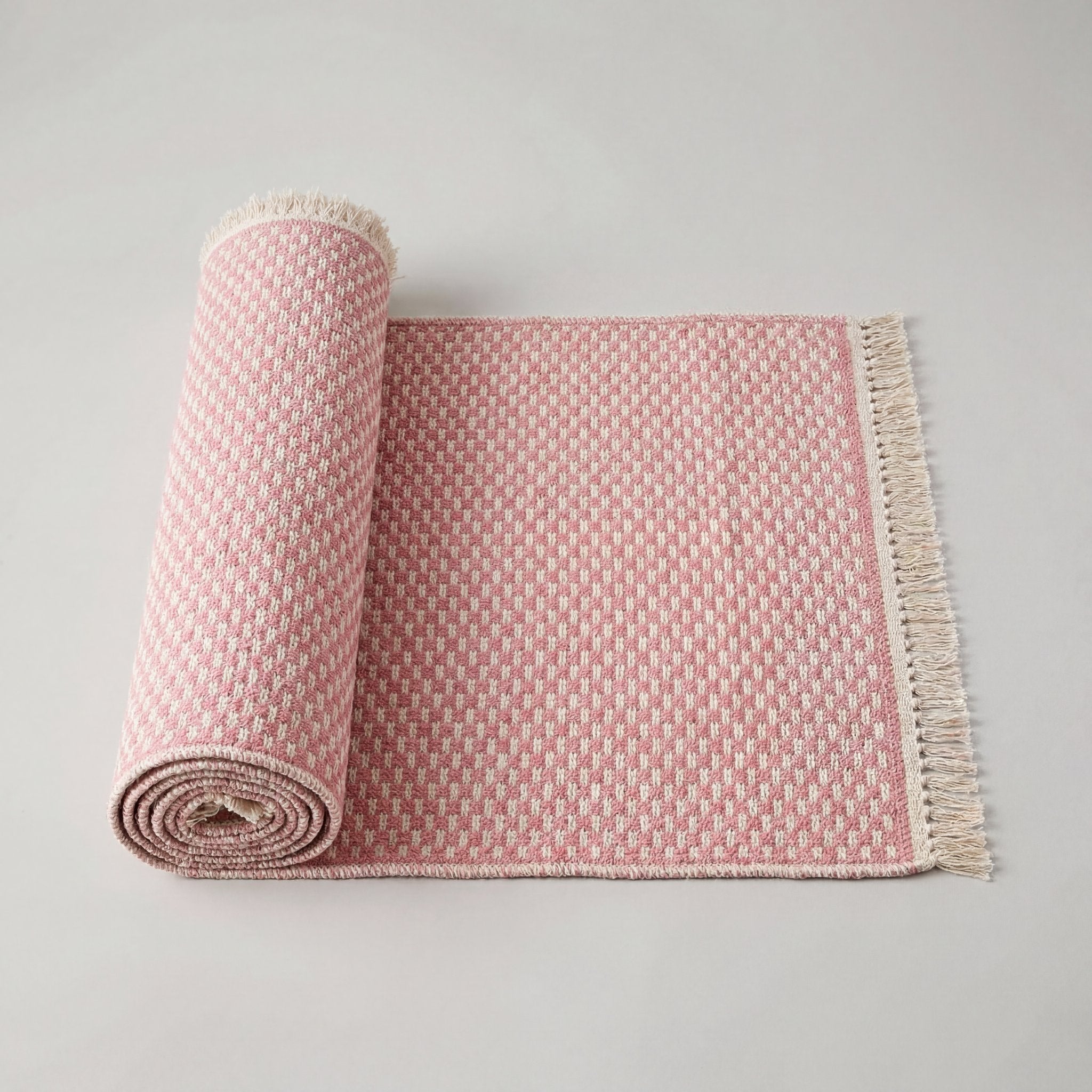 Pink geometric check washable runner rug rolled up, lightweight and easy to handle