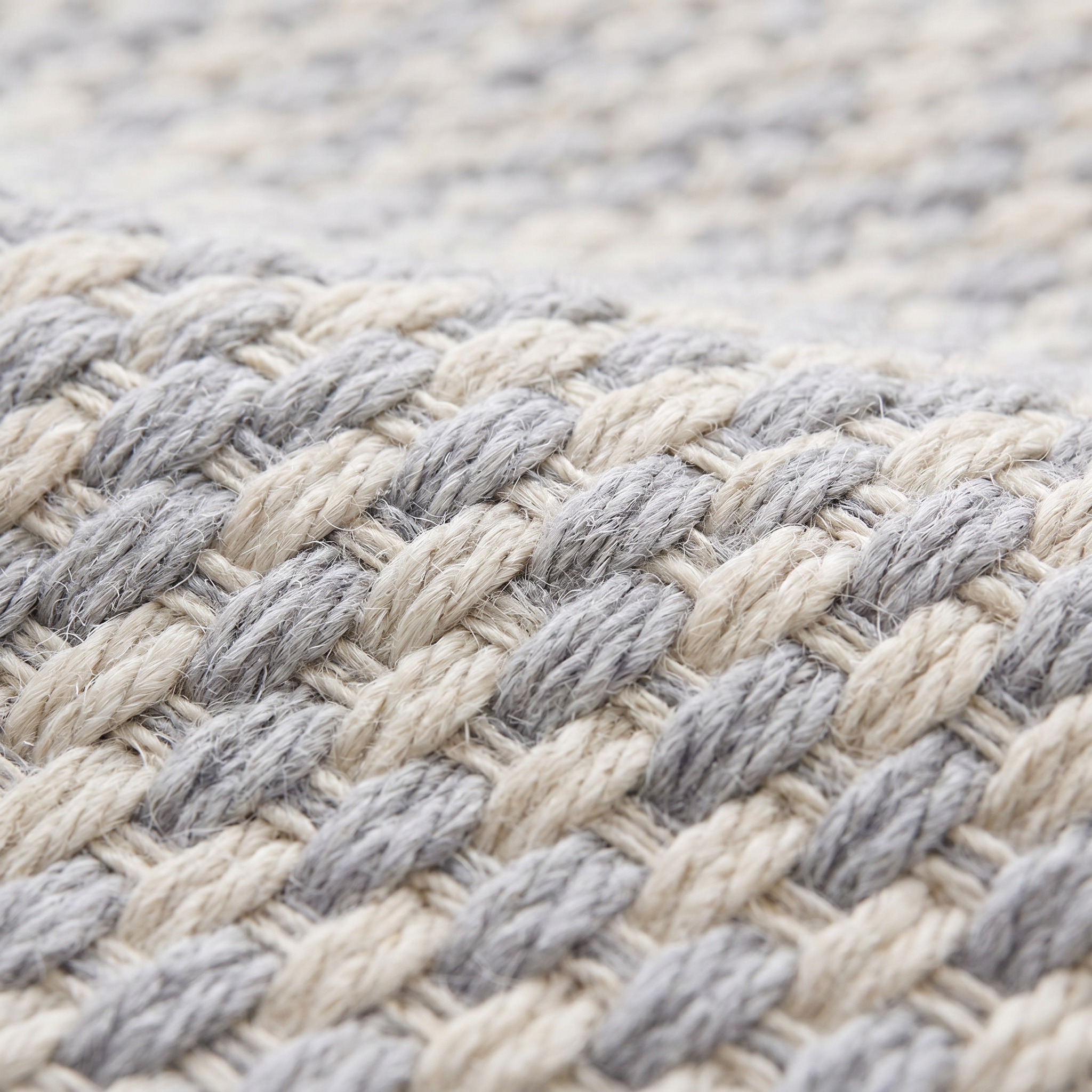 Close-up of the flat-woven kilim weave texture of the light gray geometric check rug