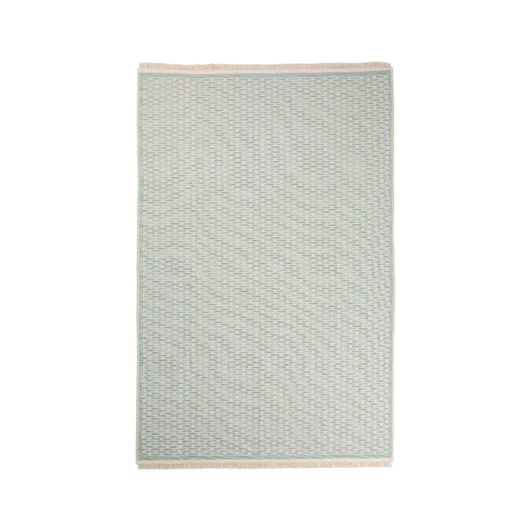 Green geometric check low-pile machine washable area rug in a bright, dust-free living room