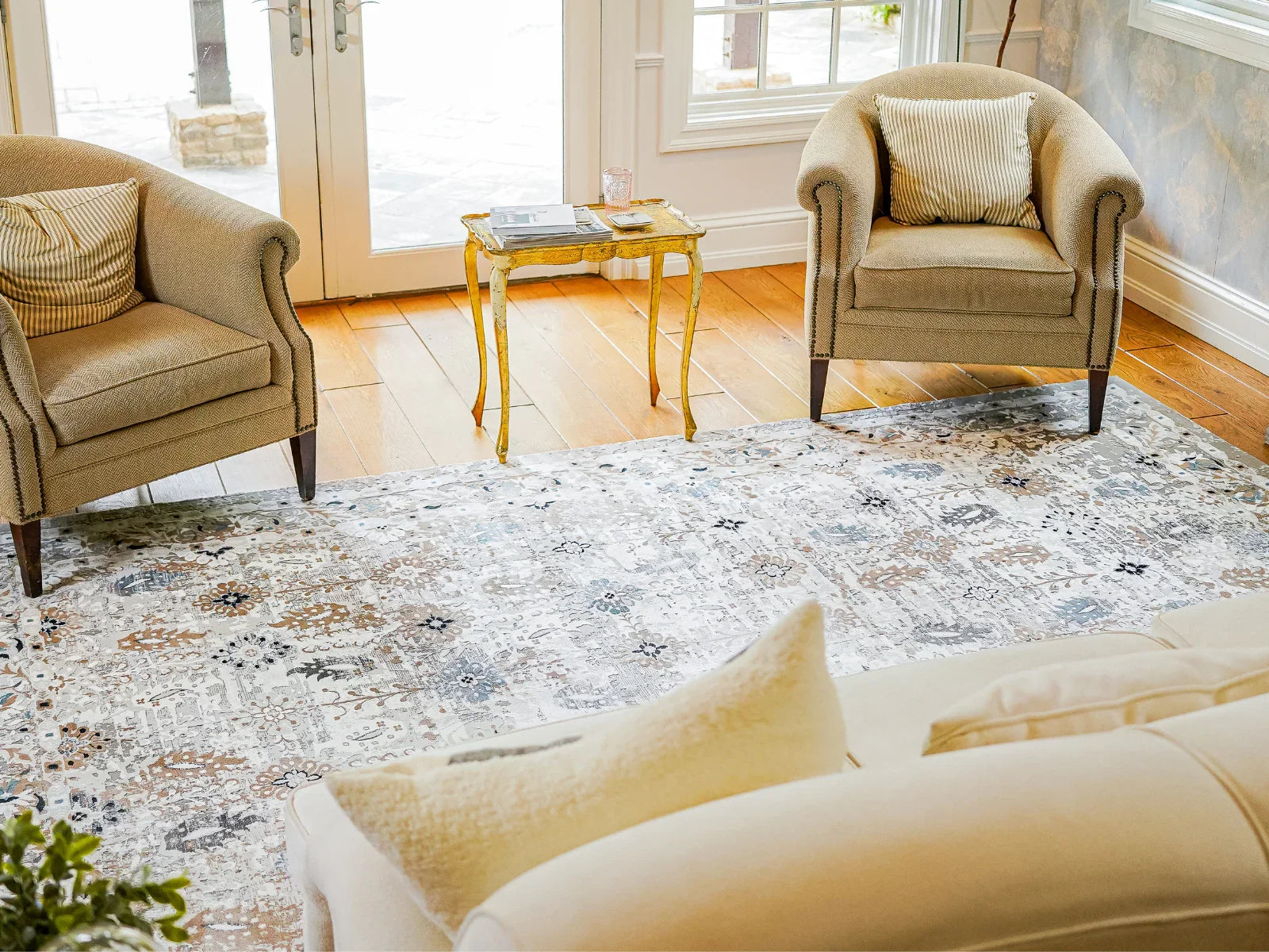 Bohemian style washable area rug in cozy living room with armchairs and wood floor