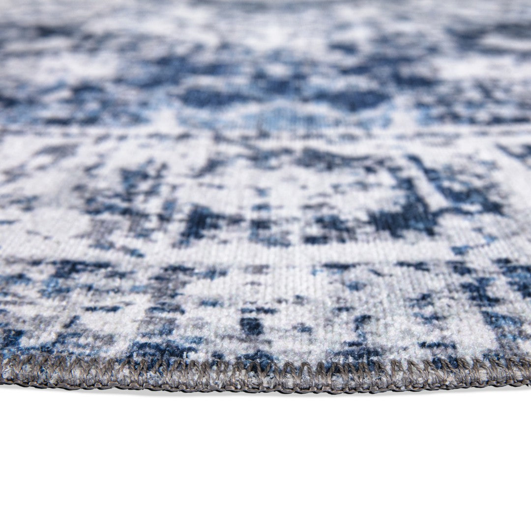 Machine washable area rug in blue and white, recycled material, available in 5x7 and round size, kid-friendly, pet-friendly, eco-friendly design, navy blue, white, distressed blue tones