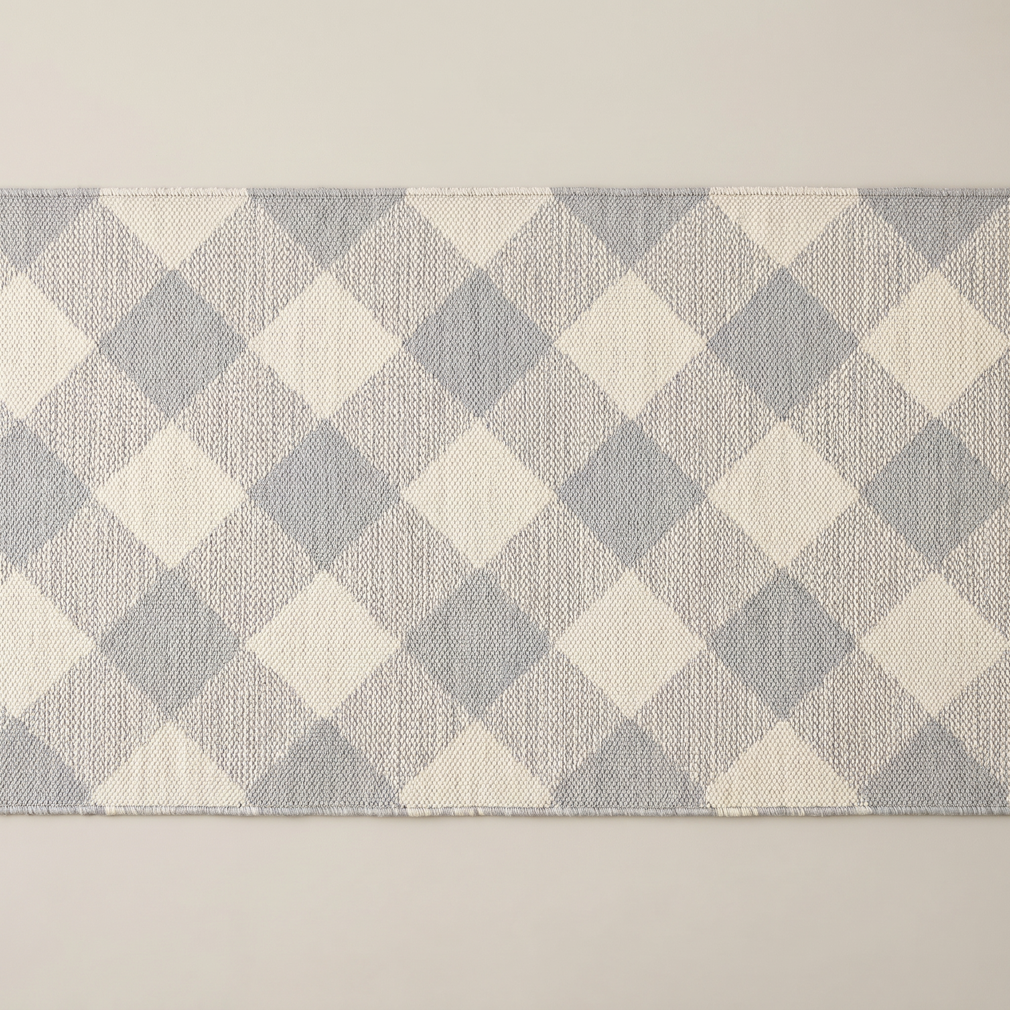Light gray geometric check machine washable runner area rug, top-down studio shot