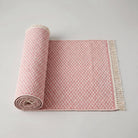 Pink geometric check washable runner rug rolled up, lightweight and easy to handle
