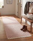 Pink geometric check washable runner rug in a home entryway by the front door