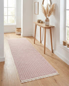 Pink geometric check washable runner rug styled in a modern hallway