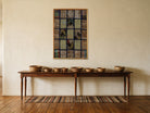 Navy & Tan Kilim Patchwork on Muted Brown woven wall art shown hanging in a styled room, for scale - WA-PCH-NAV-6595-065